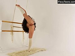 Brunette gymnast Myra Zavisalo spreads her legs and stretches