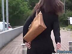 Asian slut pisses on the street in front of her lover
