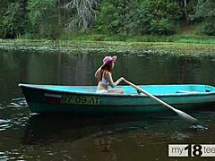 Cute girl enjoys self-pleasure in boat with dildo