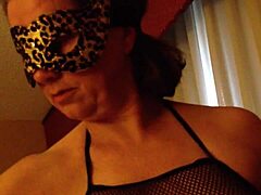 A mature wife indulges in oral pleasure with her spouse, donned in a mask for added excitement.