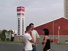 A steamy encounter on a public street involving a petite girl and two men, featuring intense oral pleasure and an orgy